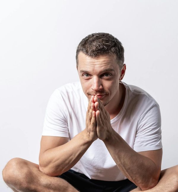 Person meditating peacefully with a serene expression.